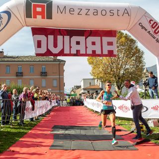 Catherine Bertone all'arrivo della Mezzaosta 2019 applaudita da Jean Dondeynaz presidente Fidal VdA